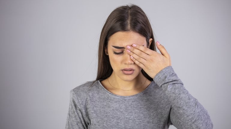 Frau hat Schmerzen am Auge wegen Entzündung.