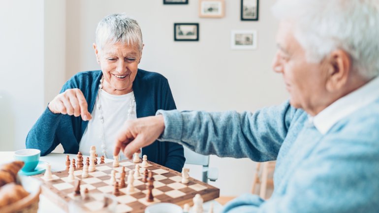 Zwei Senioren spielen Schach.