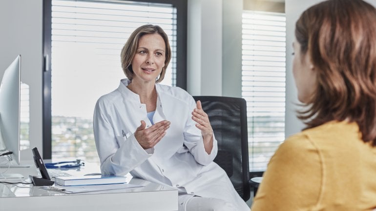 Ärztin klärt Patientin über Möglichkeiten der Krebstherapie auf.