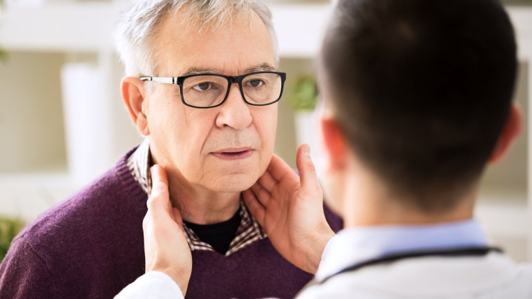 Ein Arzt tastet beim Patienten die Lymphknoten ab.